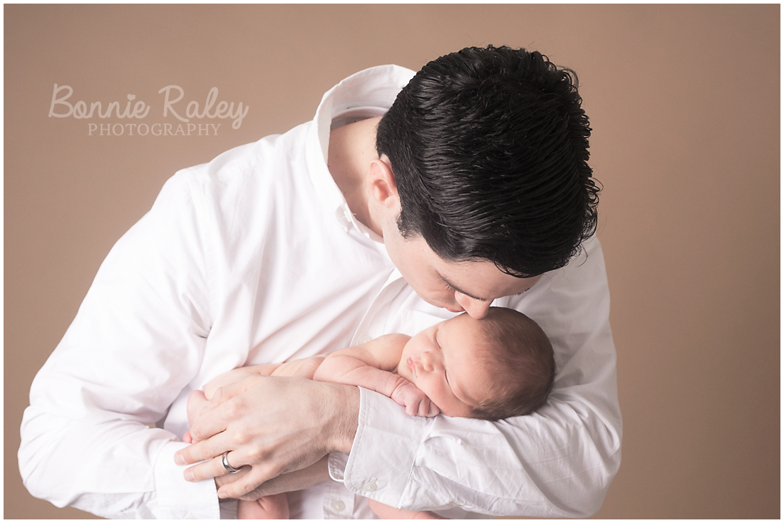 dad holding his newborn baby boy {main line newborn photographer}