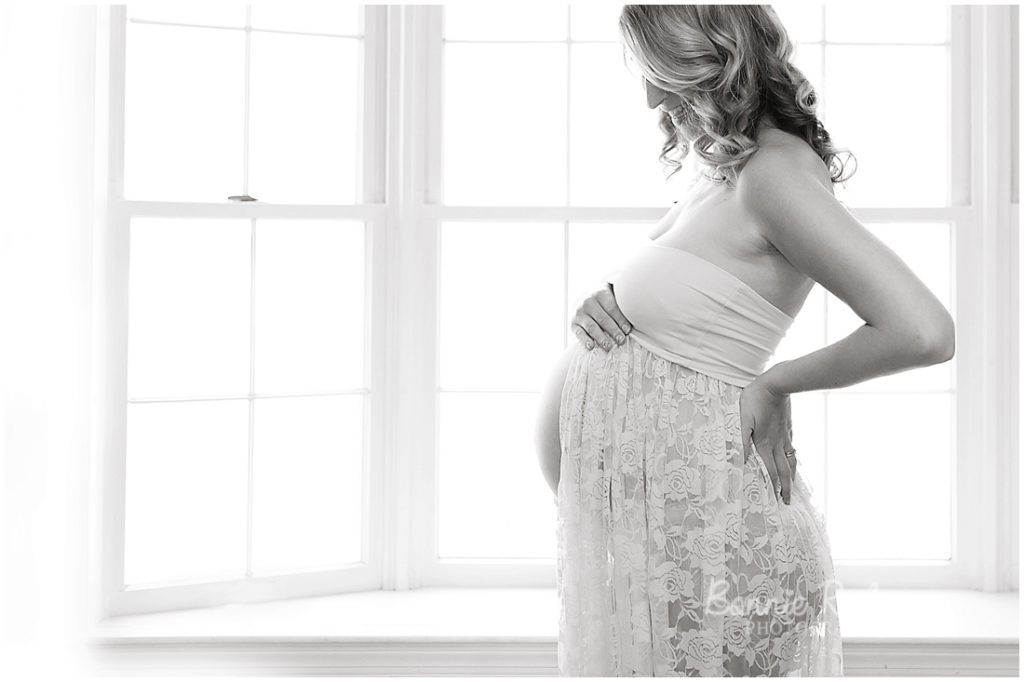 backlit window light pregnant belly lace gown