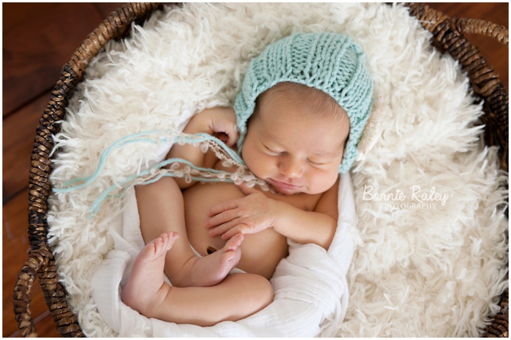 newborn baby girl with blue bonnet