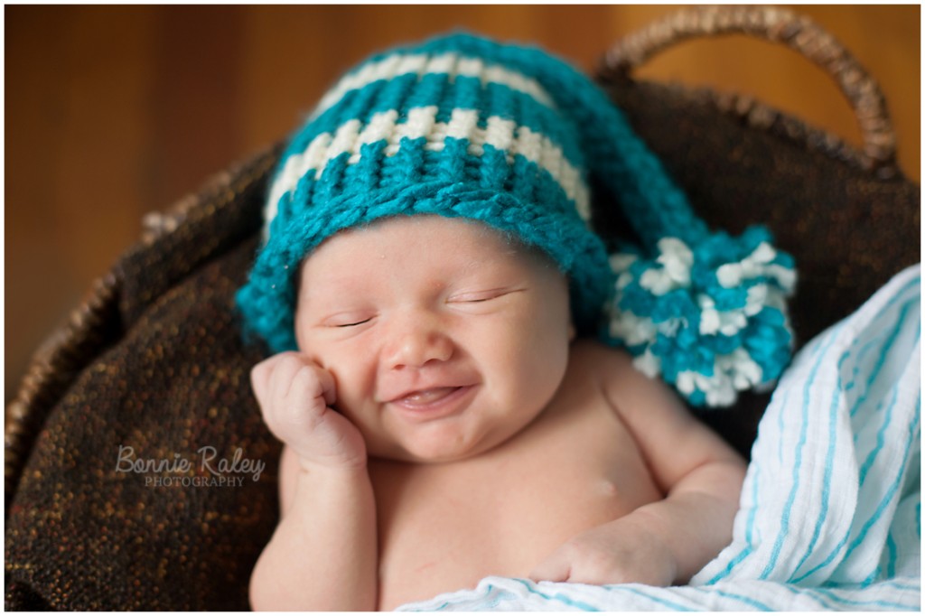 newborn boy smiling