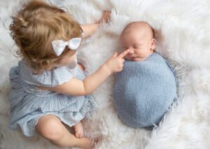 big sister helping new baby