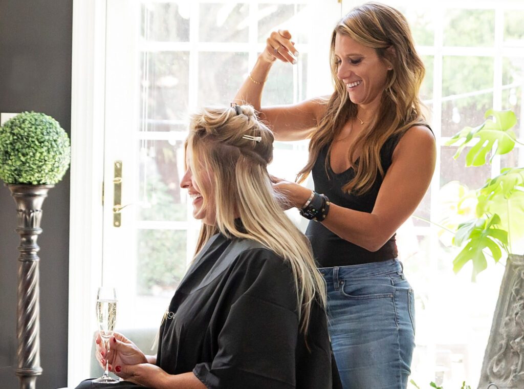 Hair stylist working with client during branding photography session for hair salon company